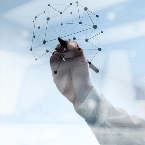 person drawing a network on a glass board