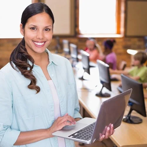 woman working on laptop with a background of people on computers