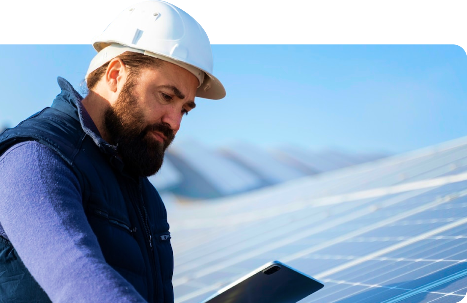 man in hard hat working on solar panel